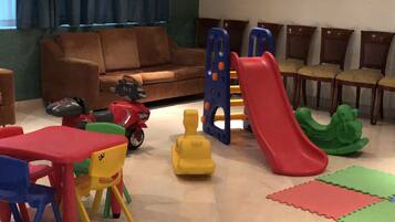 Children can play on the play structure with slides and enjoy the toy car and figure.