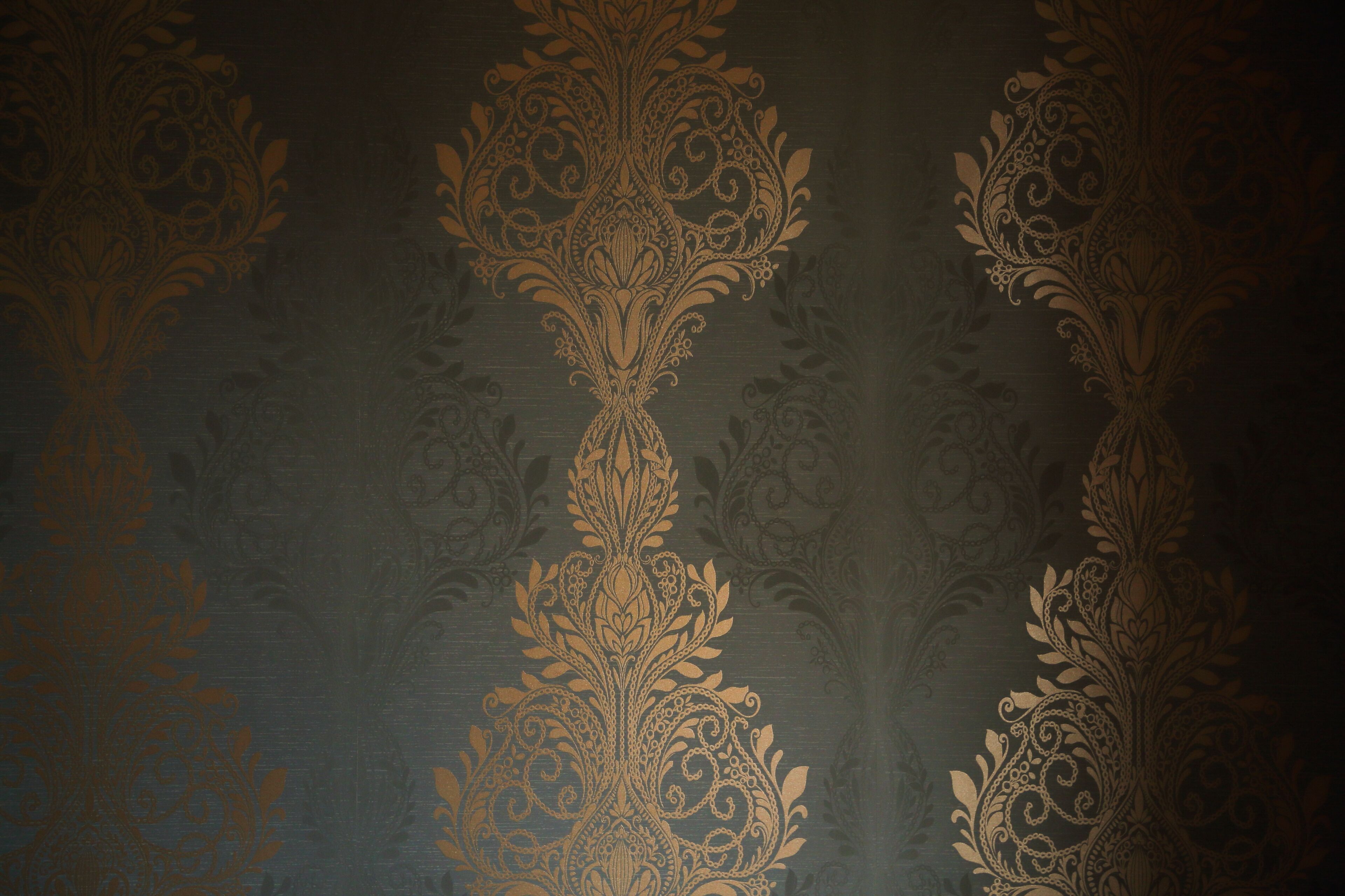 A patterned wallpaper with a symmetrical design.