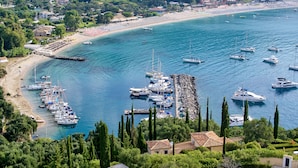 A coastal town with a marina, beach, and residential buildings. - Parga Beach Resort (Parga)