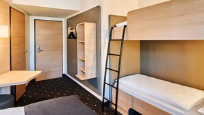A compact hotel room with a bunk bed, a desk, and a wardrobe. - B&B Hotel Frankfurt-Niederrad (Frankfurt)