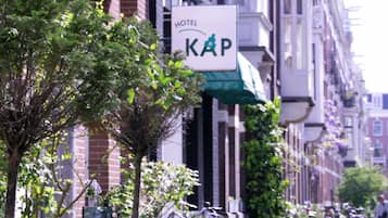 A hotel sign with the name "KAP" and a green awning.
