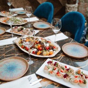 A dining table set with plates of food, glasses, and cutlery. - Sander (Amsterdam)