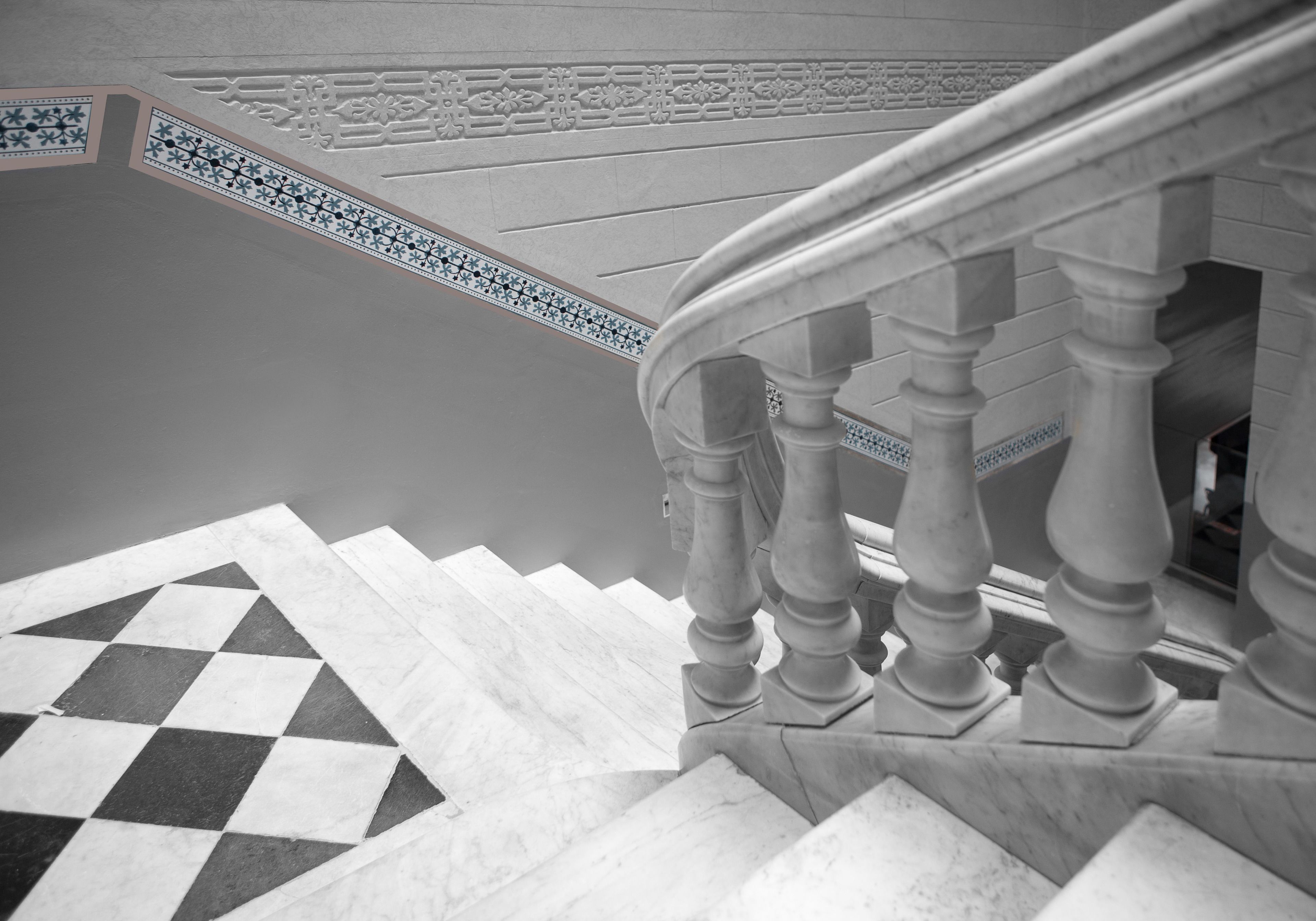 A staircase with a checkered floor pattern and a balustrade.