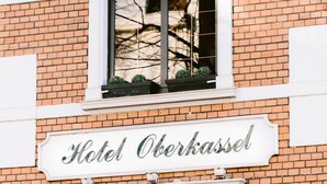 A hotel sign with the name "Hotel Oberkassel" above a window. - Boutique Hotel Villa Oberkassel (Düsseldorf)