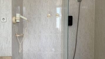 A bathroom with a shower, toilet, and sink.