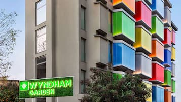 A multi-story building with a sign for 'Wyndham Garden'.