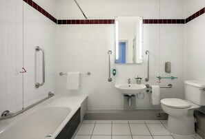 A modern bathroom with a bathtub, toilet, and sink.