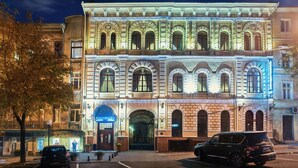 A historic building with a grand entrance, multiple windows, and a well-lit facade. - Ayvazovsky (Odesa)