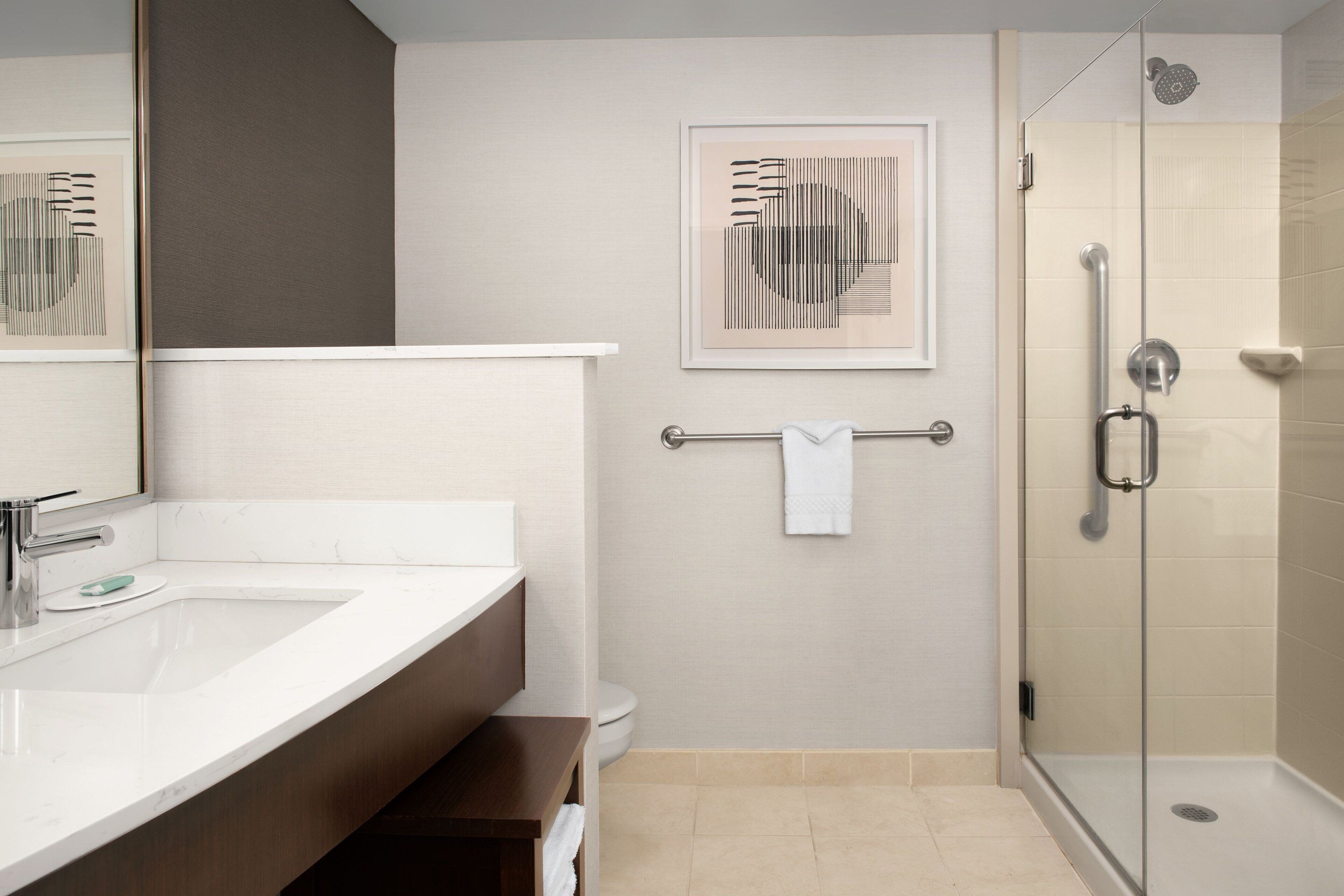 combined shower/bathtub, designer toiletries, hair dryer, towels