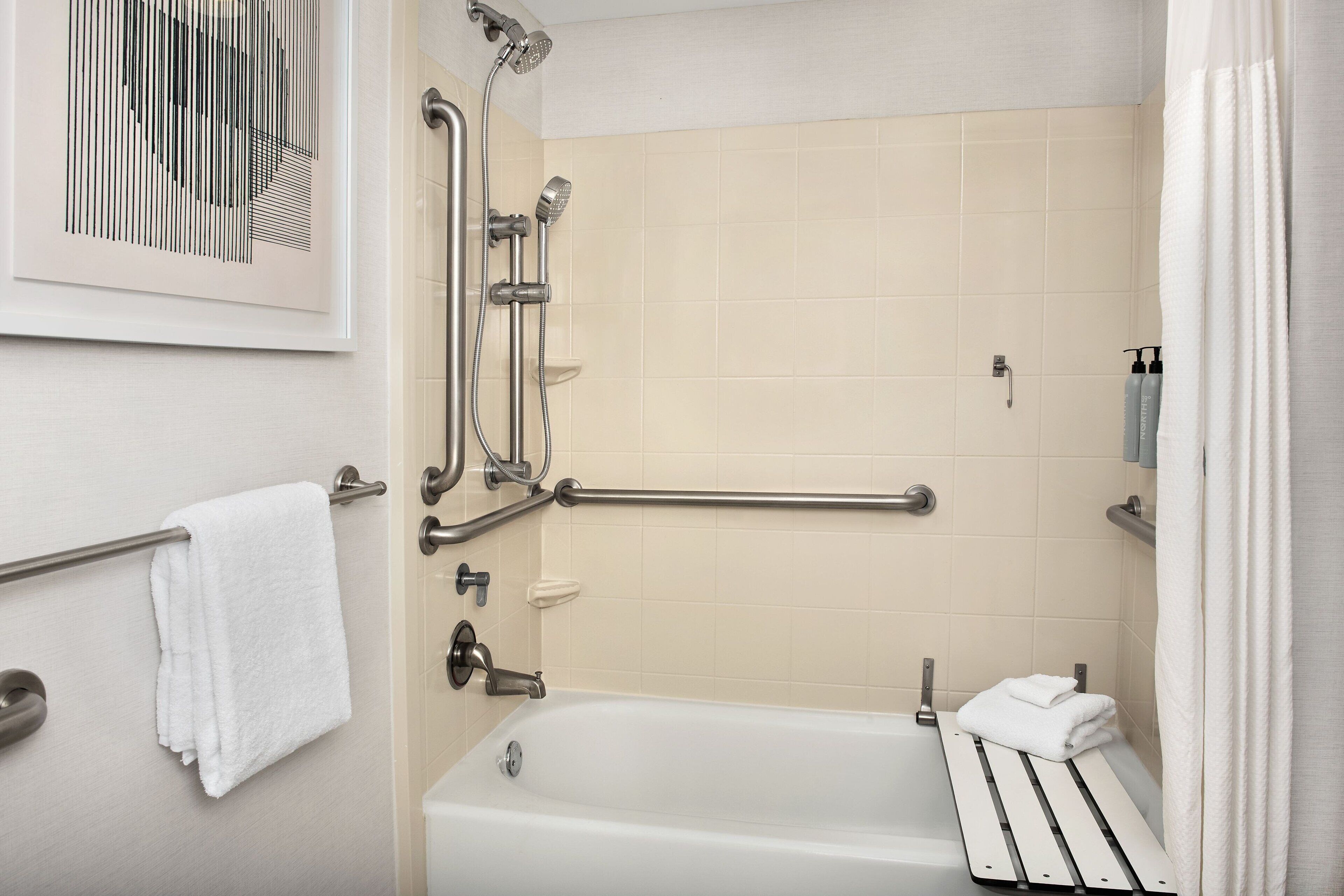 combined shower/bathtub, designer toiletries, hair dryer, towels