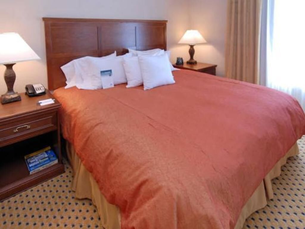 Premium bedding, desk, laptop workspace, blackout drapes
