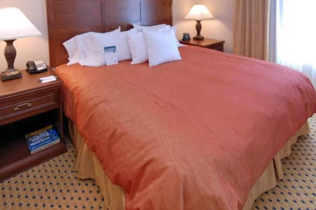 Premium bedding, desk, laptop workspace, blackout drapes
