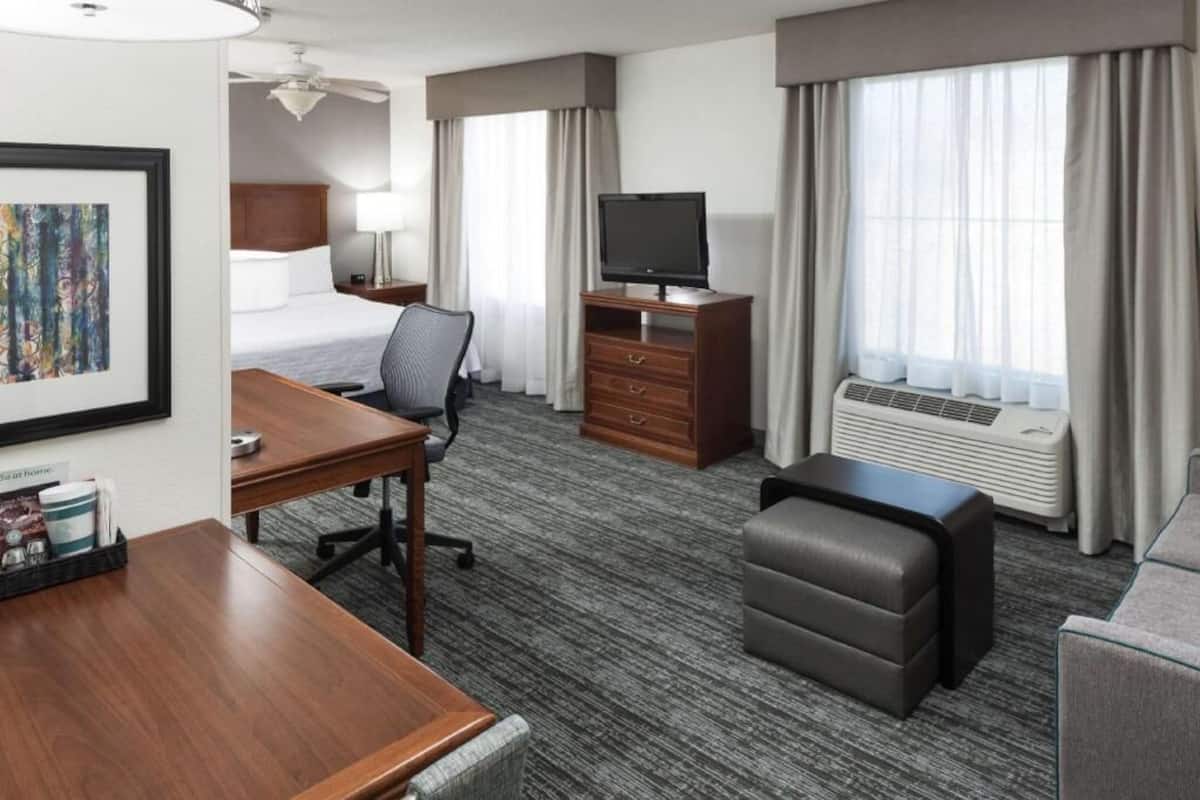 Premium bedding, desk, laptop workspace, blackout drapes