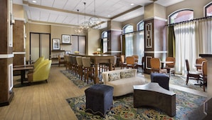 Eine geräumige Lobby mit Essbereich, Sitzgelegenheiten und einem Chandelier.