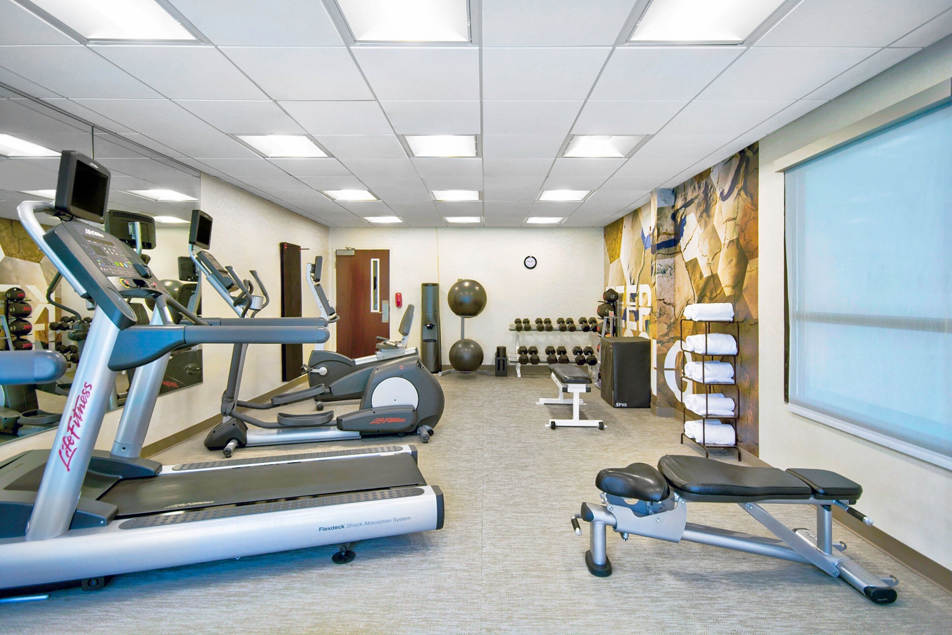 A gym with treadmills, ellipticals, and weight machines.