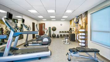 A gym with treadmills, ellipticals, and weight machines.