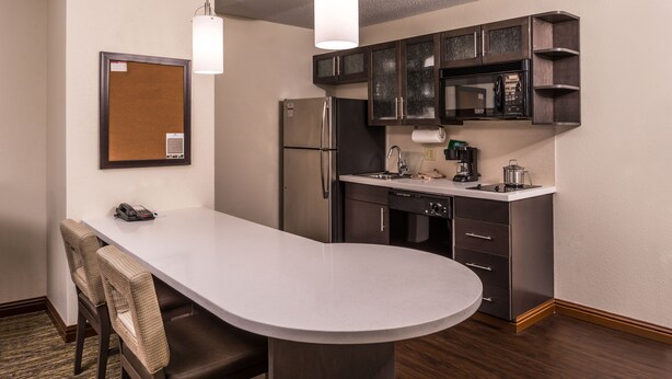 A compact kitchen with a refrigerator, microwave, and coffee maker. - Candlewood Suites Kansas City Speedway by IHG (Kansas City)