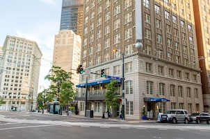 A hotel with a classic architectural style, featuring large windows and a prominent entrance.