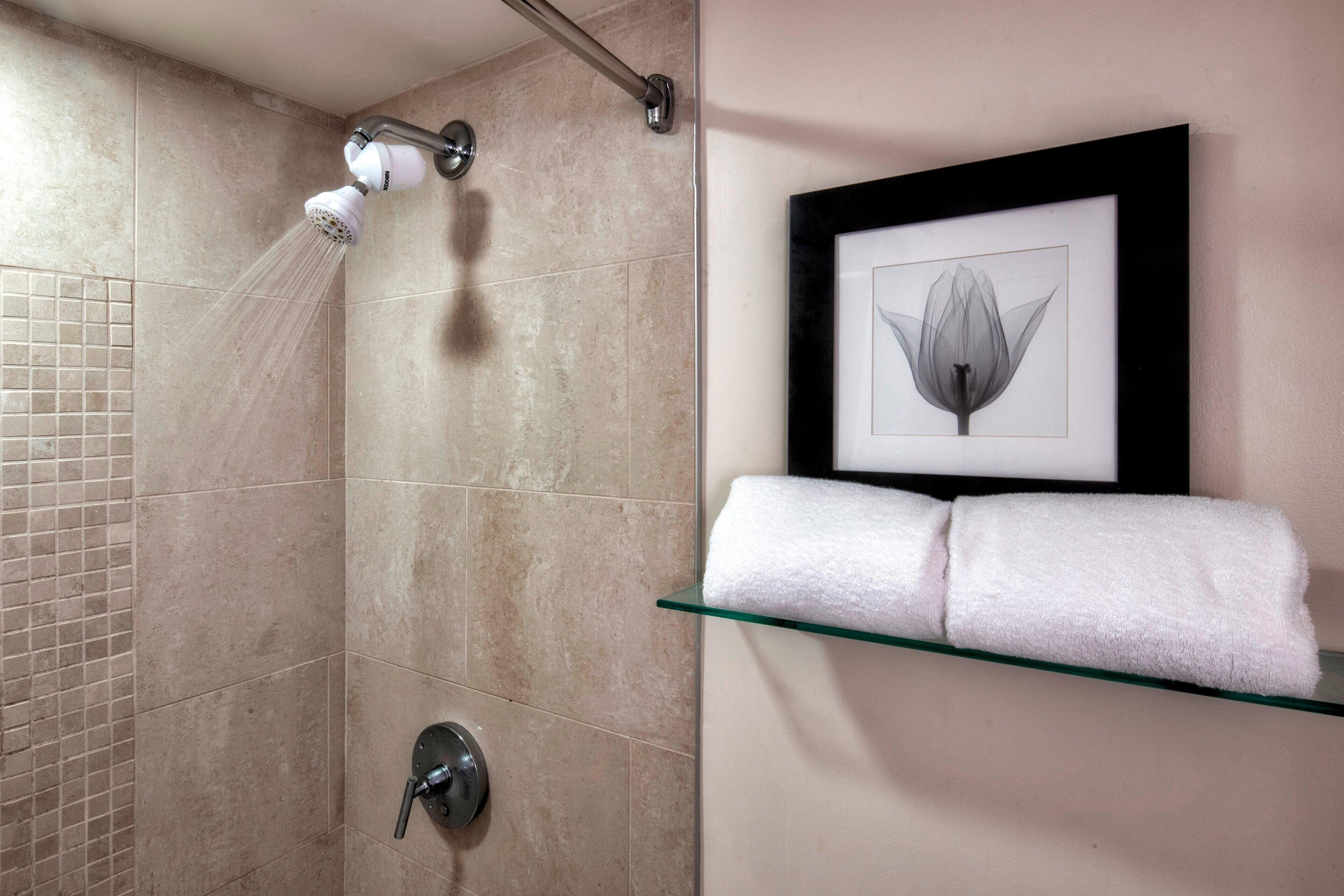 rainfall showerhead, designer toiletries, hair dryer, towels