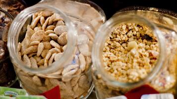Three glass jars filled with different types of cereal.