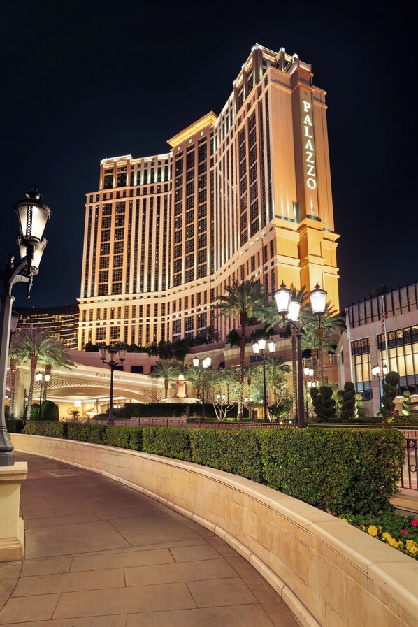 A large, illuminated hotel with a prominent sign reading "PALAZZO."