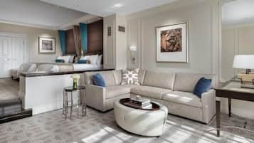 A modern living room with a sofa, coffee table, and a small side table. There is a door and a framed picture on the wall.