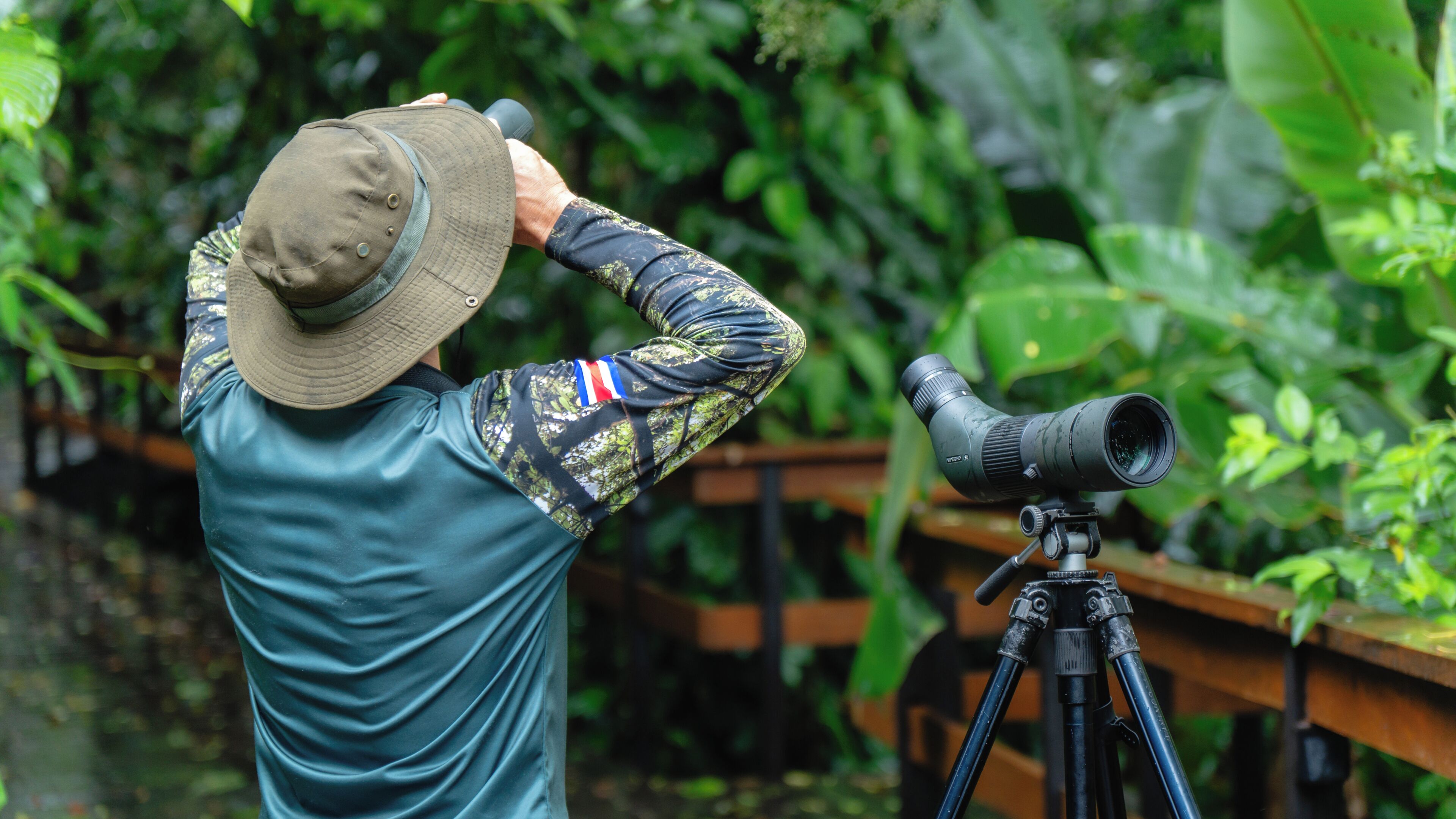 A person using a telescope on a tripod.