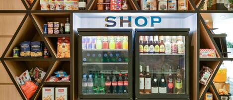 A shop with a variety of food items, beverages, and packaged goods.