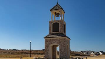 A small brick church with a bell tower and arched entrance.