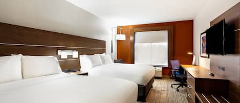 A hotel room with two beds, a desk, a chair, a TV, and a large window.