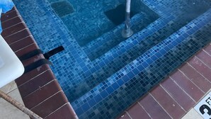 A small, square hot tub with a tiled edge and a metal ladder. - Comfort Inn & Suites Miami - Route 66 (Miami)