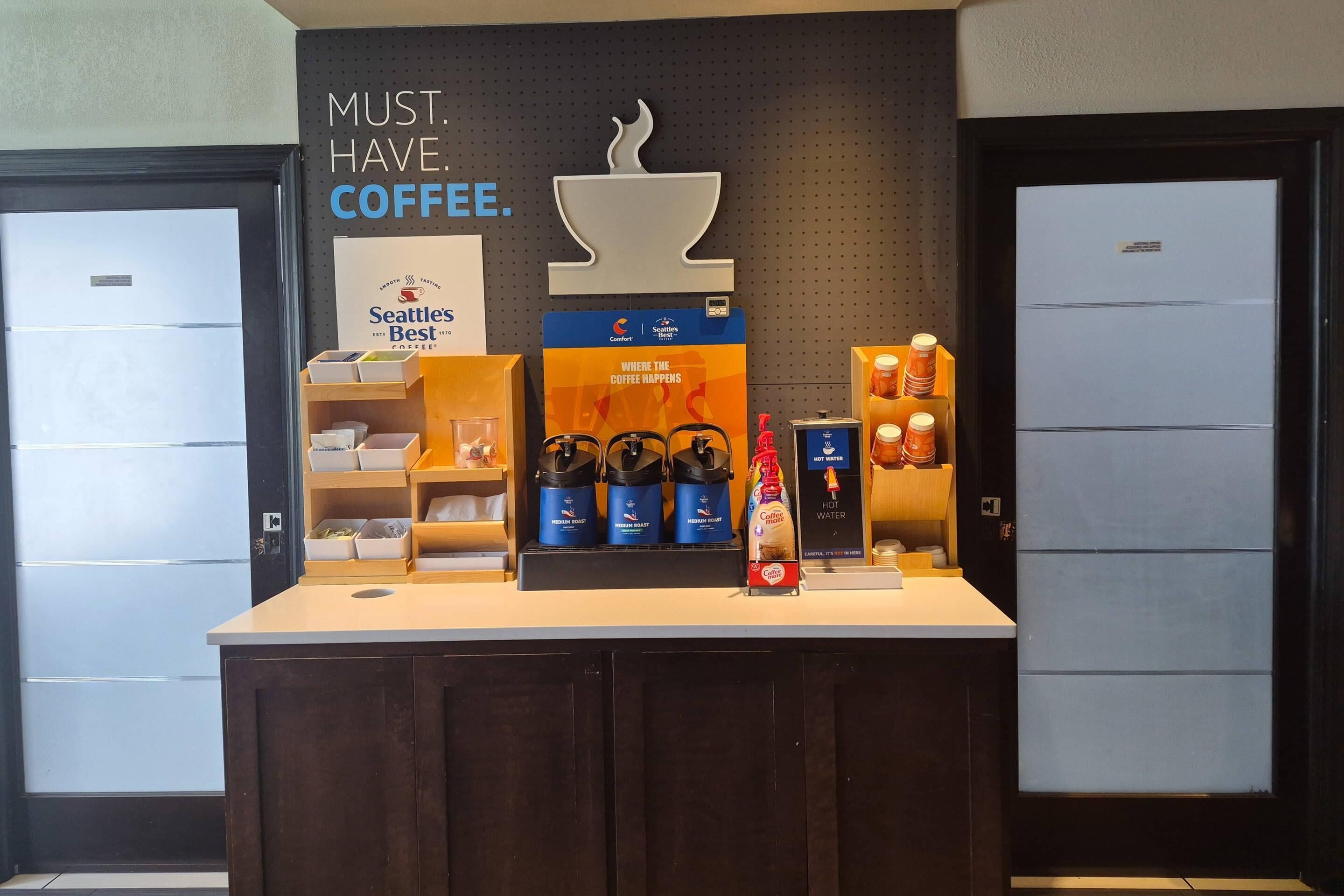 A coffee station with Seattle's Best coffee branding, a coffee machine, and various coffee products.
