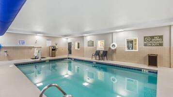 A swimming pool with no diving allowed, lifeguard on duty, and a no diving sign.