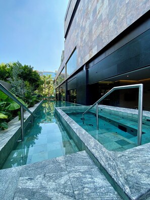 A modern building with a glass-bottomed pool, metal railings, and a clear sky. - Grand Fiesta Americana Guadalajara Country Club (Guadalajara)