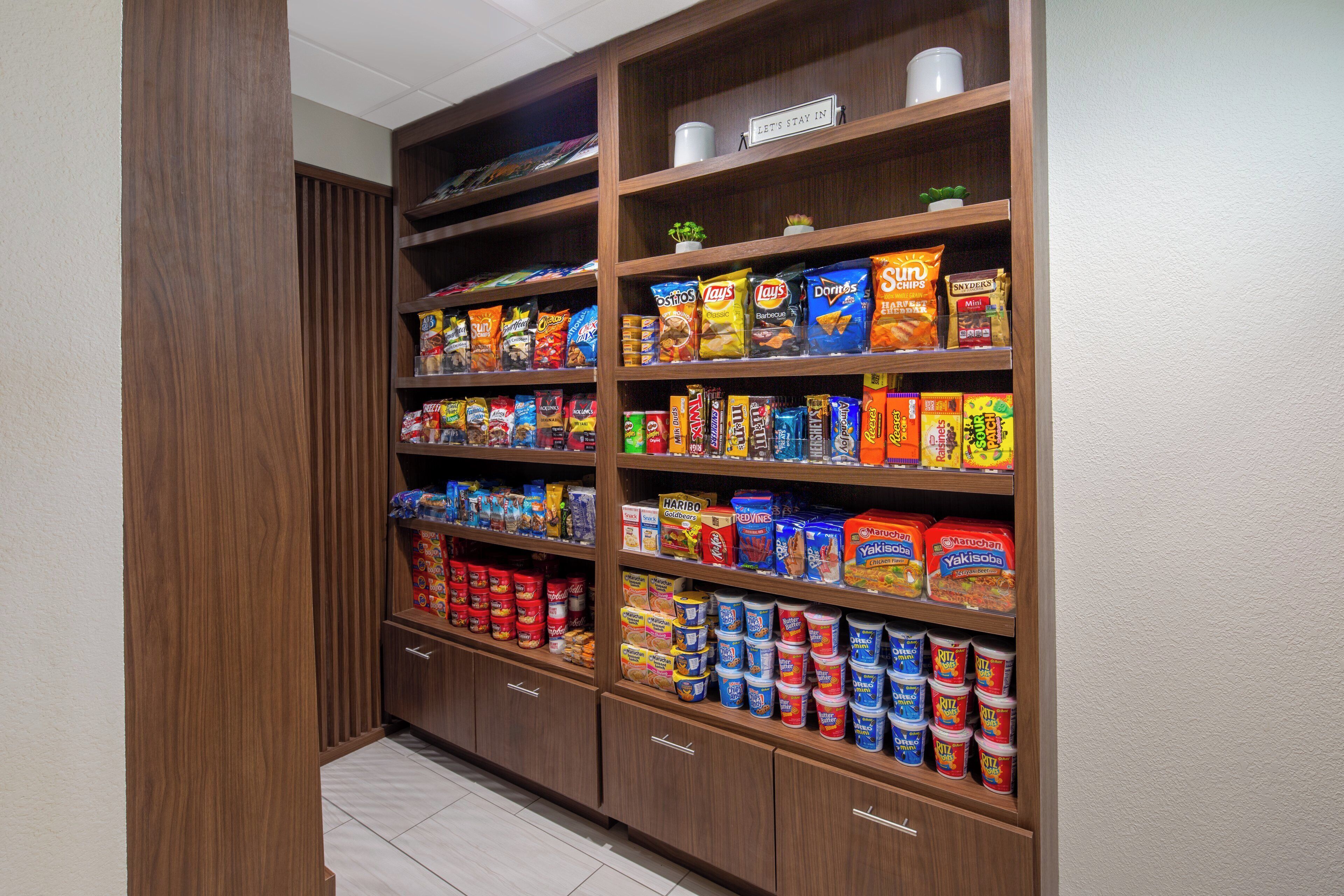 A pantry stocked with snacks, condiments, and canned goods.