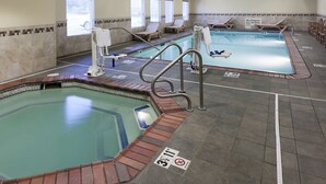 A swimming pool area with multiple lanes, safety signs, and lounge chairs. - Hampton Inn & Suites Davenport (Davenport)