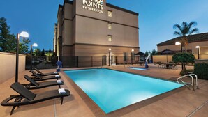 A hotel named 'Four Points by Sheraton' with a swimming pool, lounge chairs, and outdoor seating area. - Four Points by Sheraton Sacramento International Airport (Sacramento)