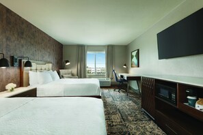 A hotel room with two beds, a desk, a chair, a flat-screen TV, and a large window with curtains. - Four Points by Sheraton Sacramento International Airport (Sacramento)
