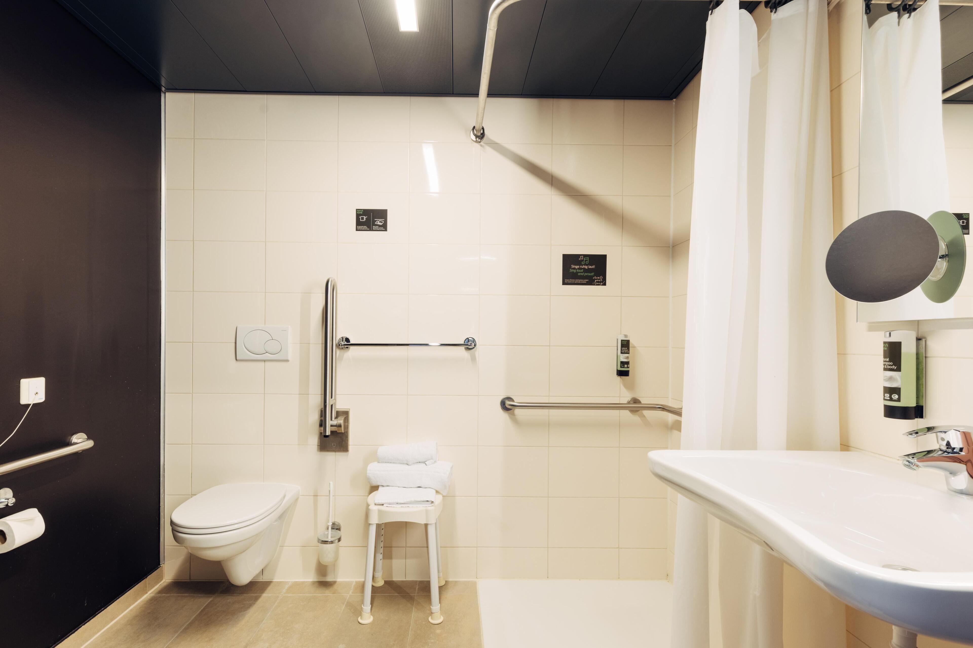 A modern bathroom with a toilet, a sink, and a shower area.