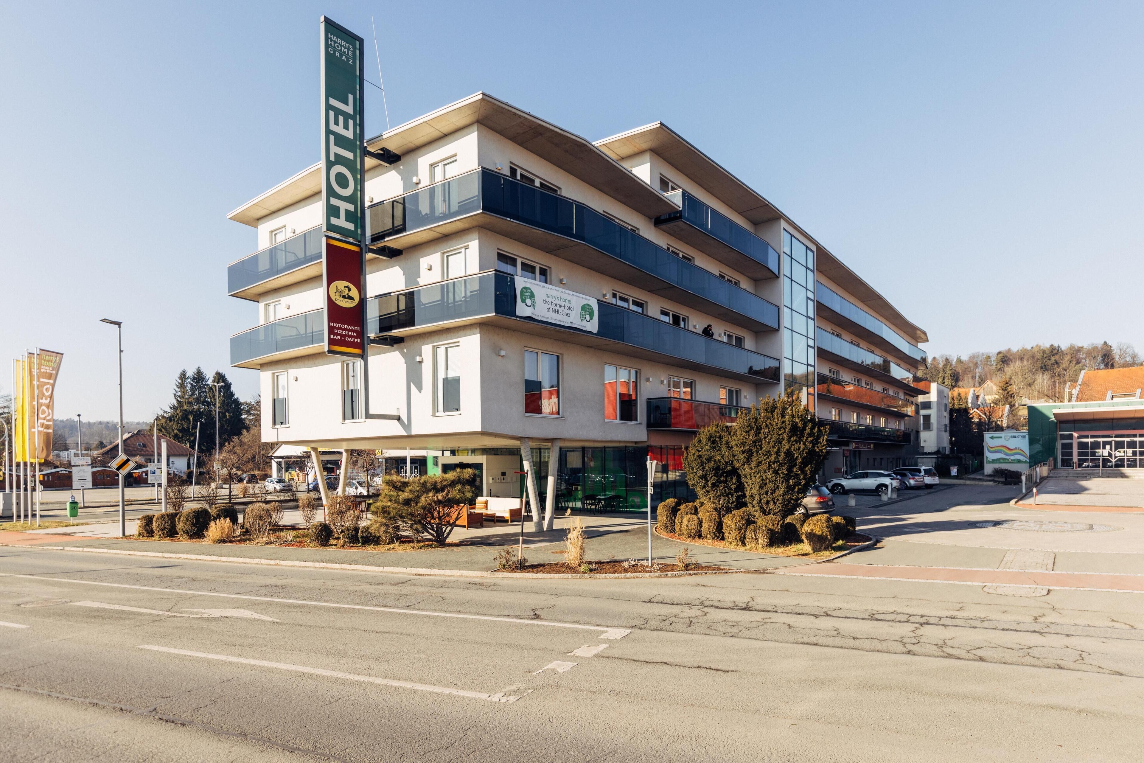 A multi-story hotel with balconies, a restaurant, and a bar.