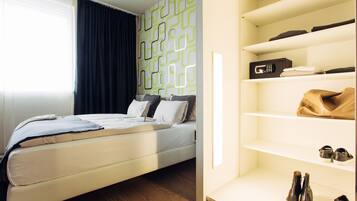 A modern bedroom with a bed, a wardrobe with shelves, and a window with curtains.