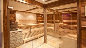 Eine Sauna mit Holzbänken und einer Steinwand.