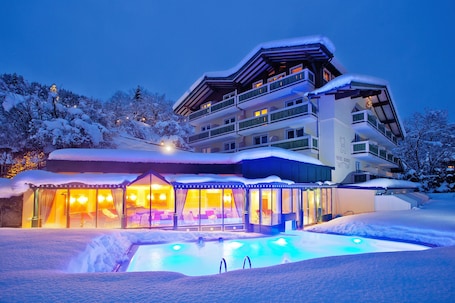 Outdoor pool, pool umbrellas, pool loungers. Hotel Berner Zell am See
