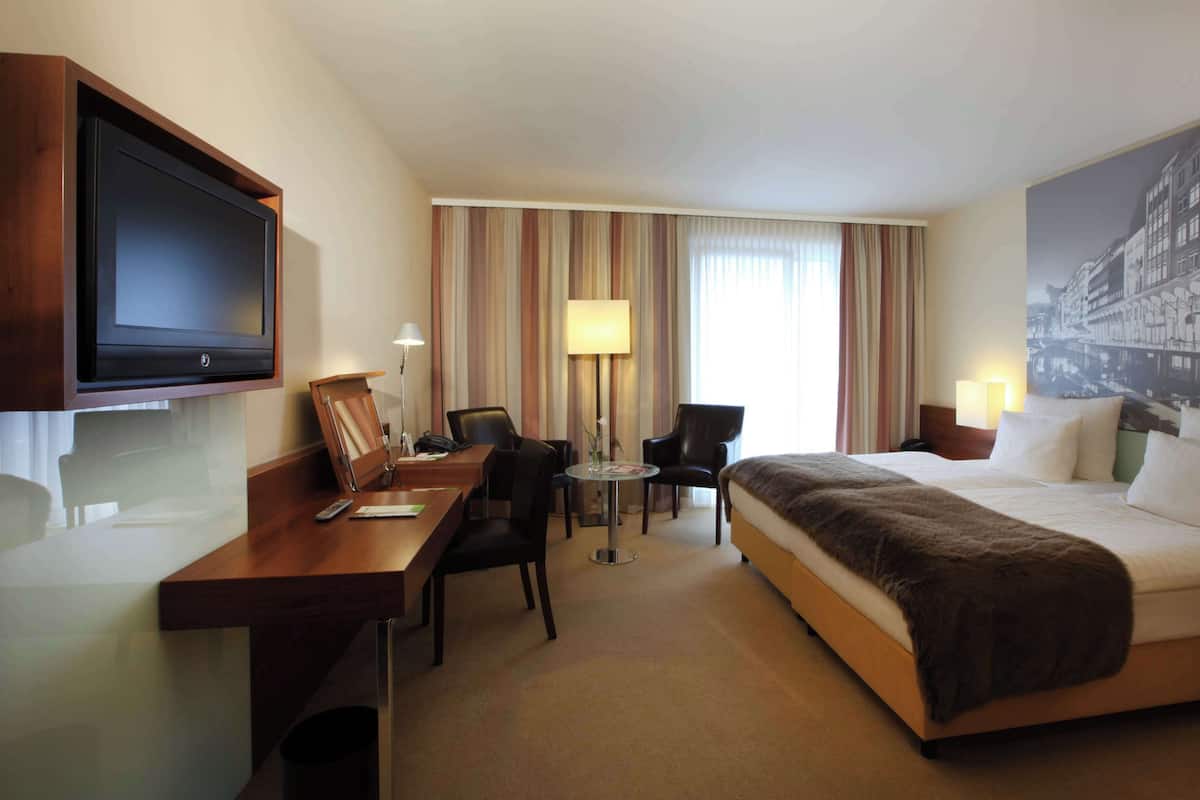 Relax in a stylish room with a large bed, flat-screen TV, and city views.
