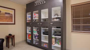 A lending locker with various board games and a framed picture on the wall.
