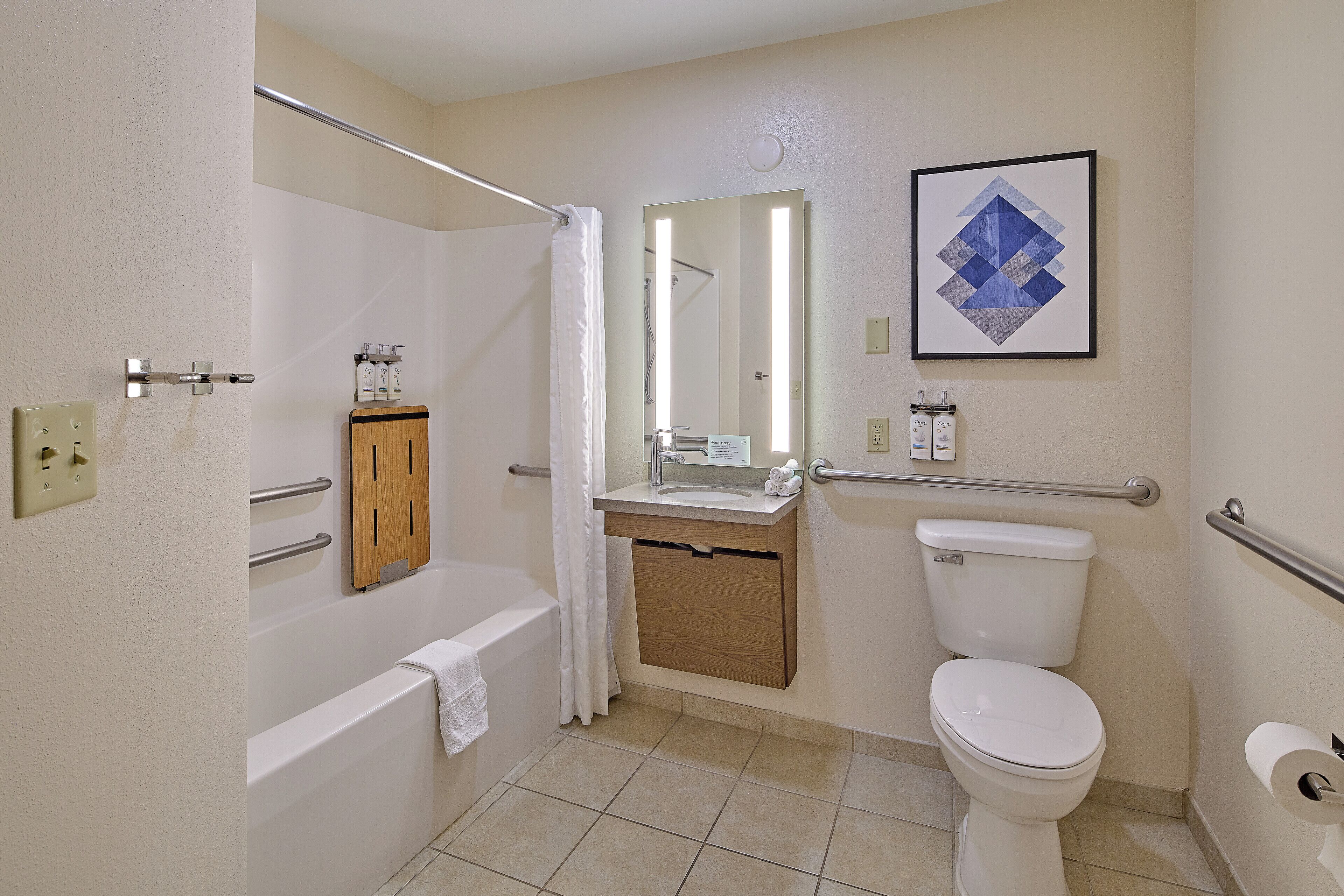 A bathroom with a bathtub, a toilet, a sink, and a shower curtain.