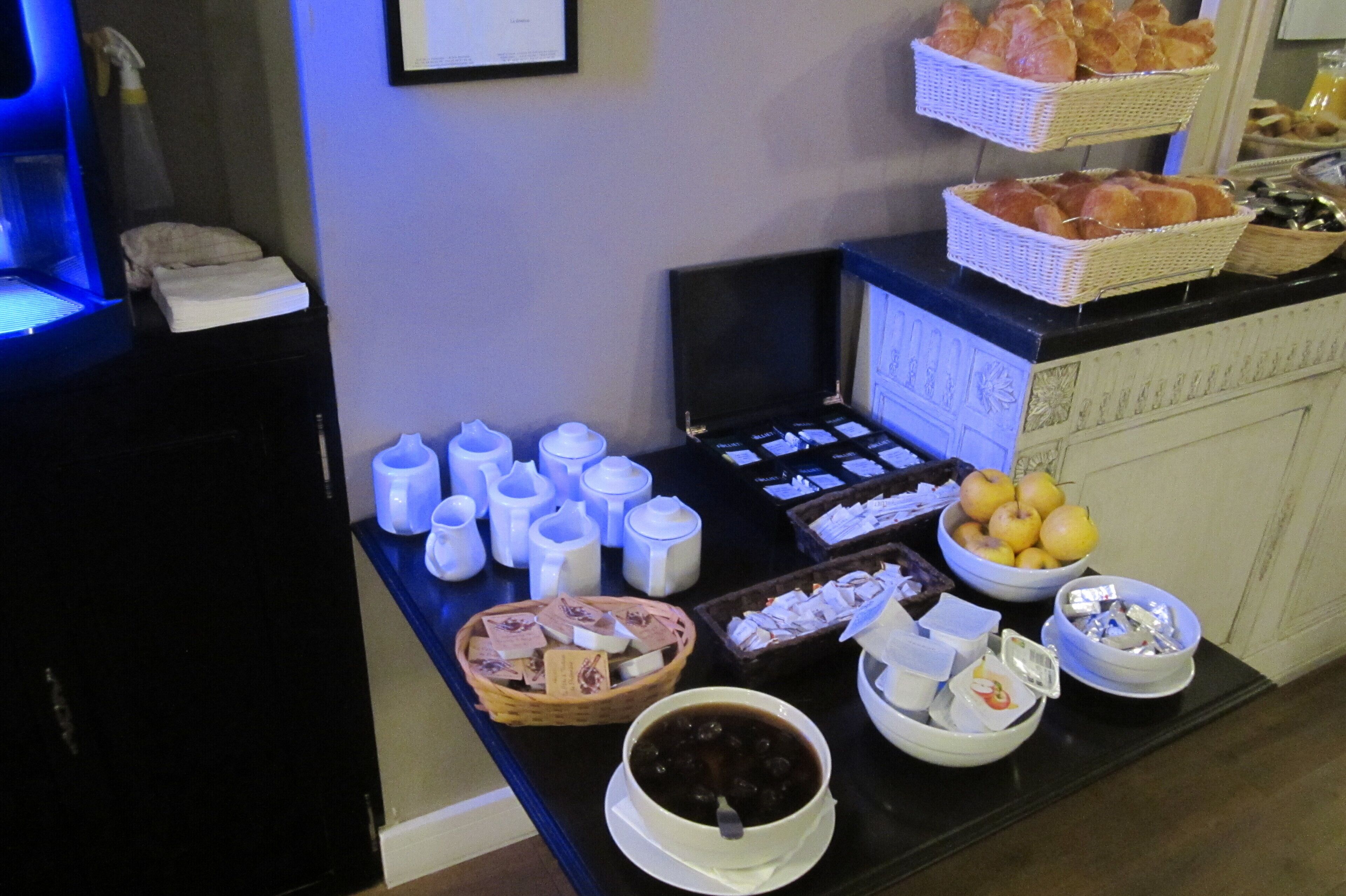 A buffet setup with various food items and condiments.