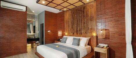 A modern bedroom with a large bed, wooden paneling, a nightstand, and a wall-mounted light fixture.