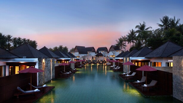 A resort with overwater bungalows, a swimming pool, and palm trees. - FuramaXclusive Resort & Villas, Ubud (Mas)