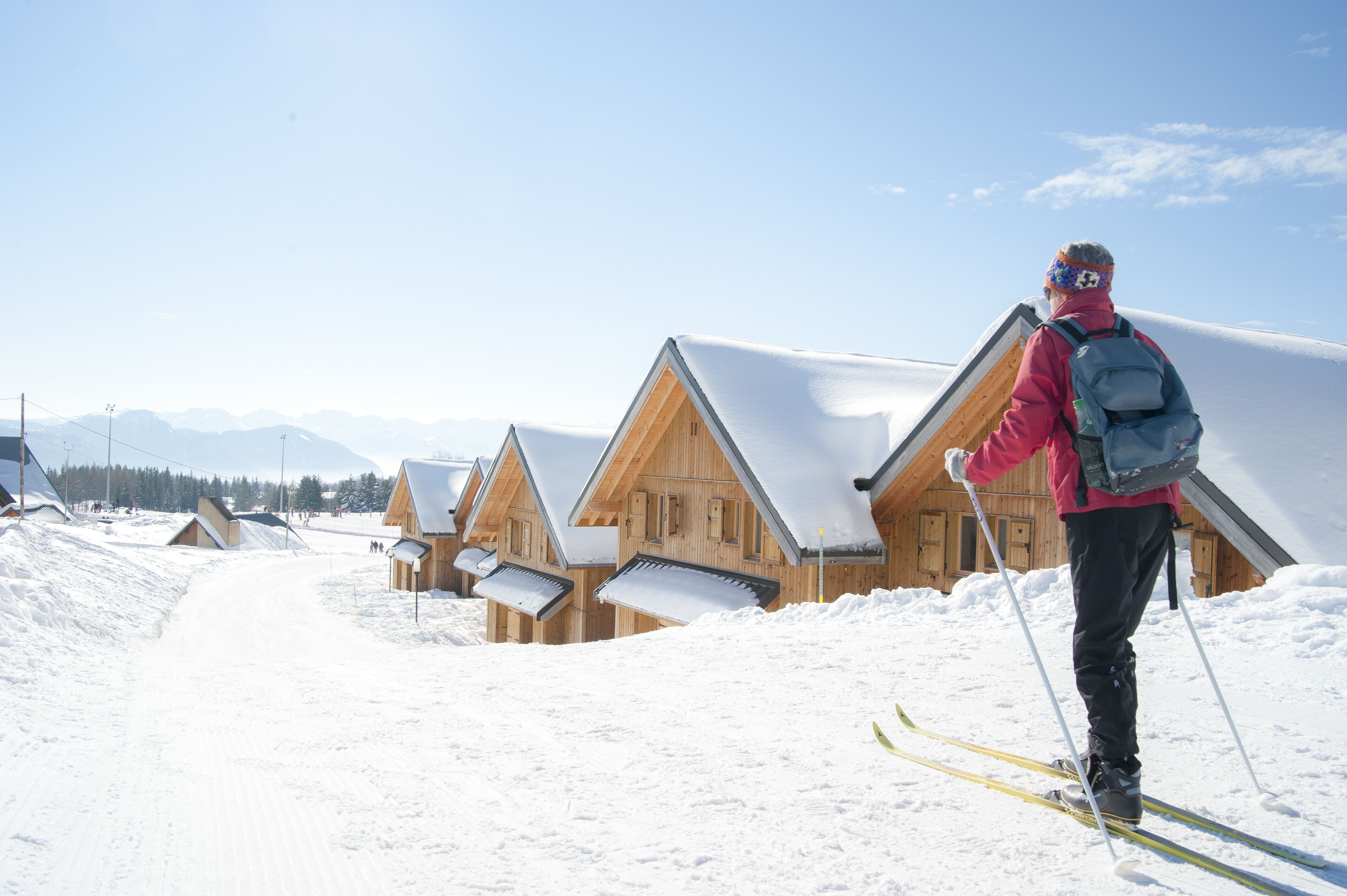 A wooden chalet-style building with a sloped roof, surrounded by snow-covered ground.